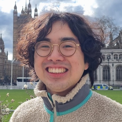 Bill, smiling, outside the Houses of Parliament